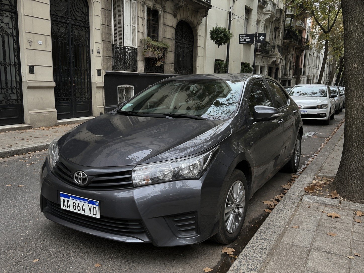 [Auto Toyota Corolla blanco limpio bajo la luz solar]